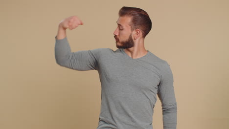 fit sporty lebanese man showing biceps and looking confident, feeling power strength success win