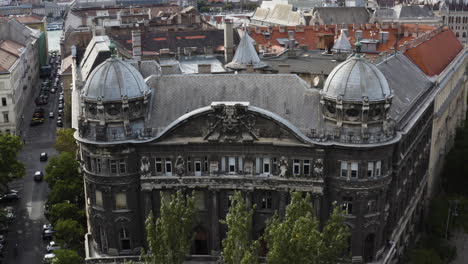 AERIAL---Adria-Palance-historial-landmark-in-Budapest,-Hungary,-reverse-shot