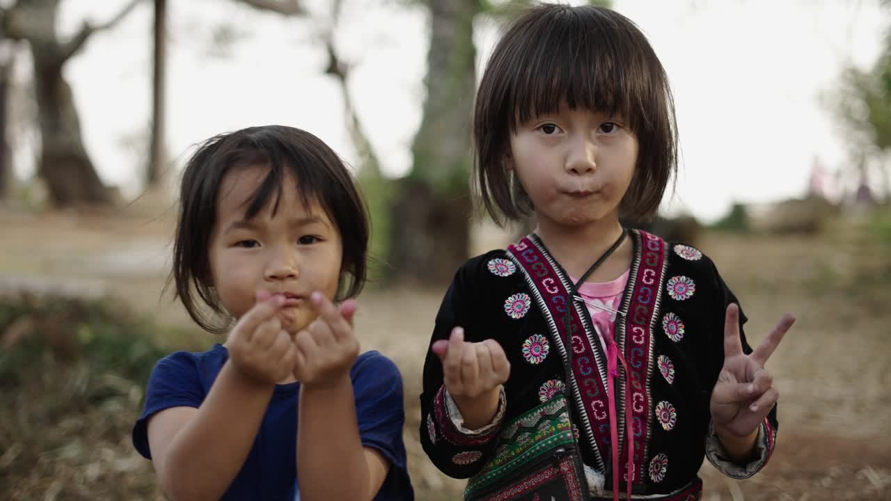 Two Young Indigenous Girls Posing Outdoors