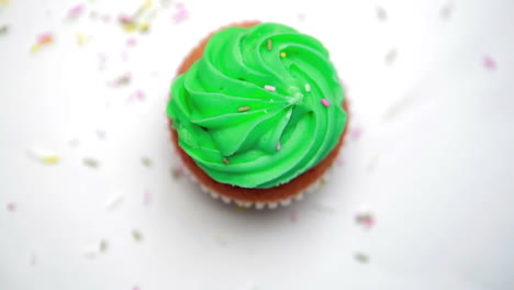 st patricks day cupcake turning with sprinkles falling