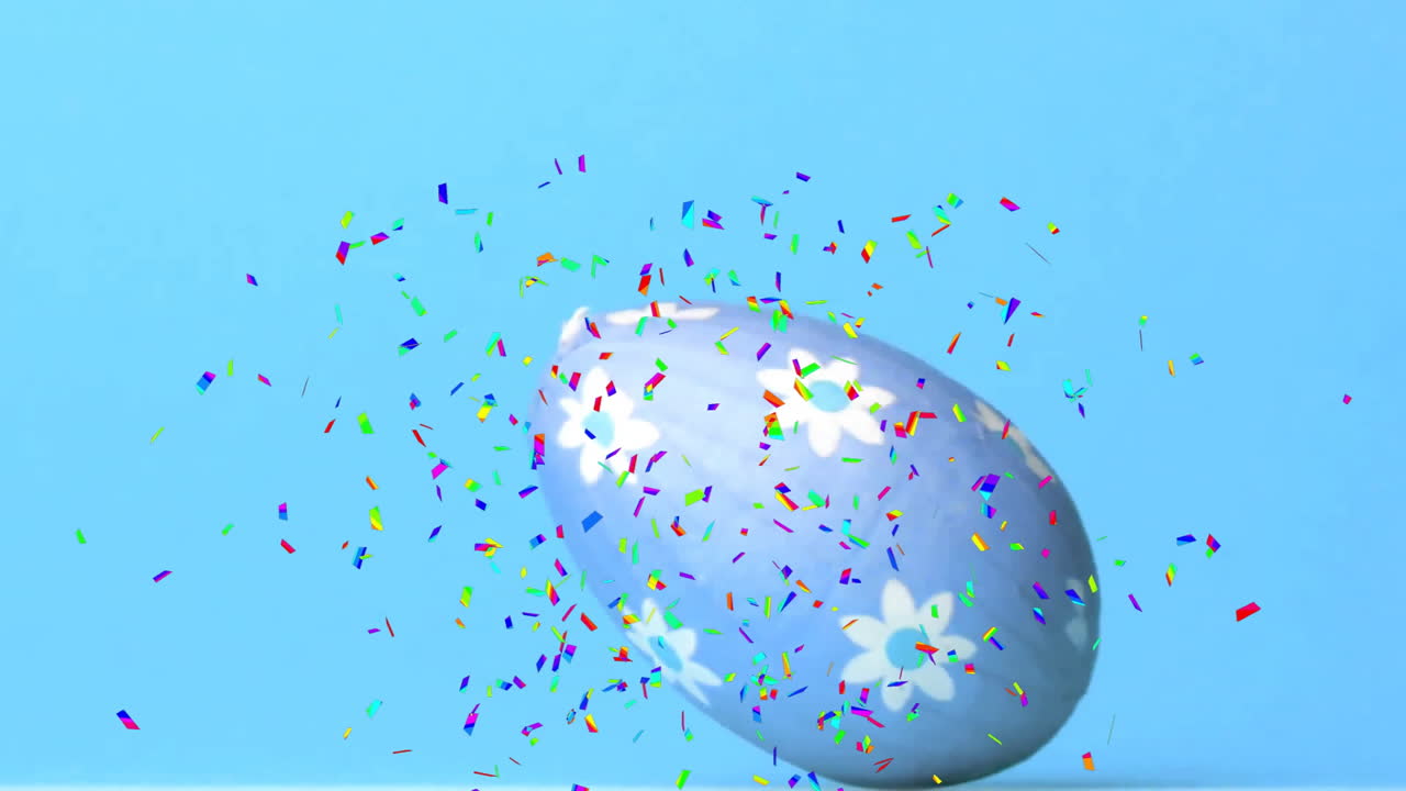 Animation of confetti falling over easter egg on blue background