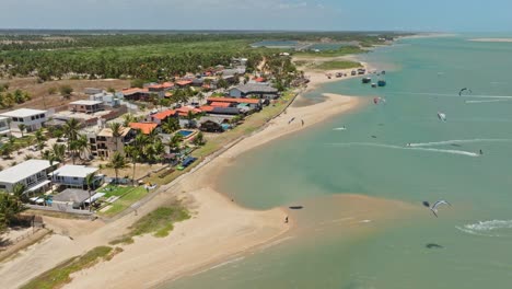 Drone-shot-of-the-beach-at-Ilha-do-Guajiru-with-a-lot-of-kitesurfers-riding-in-the-lagoon