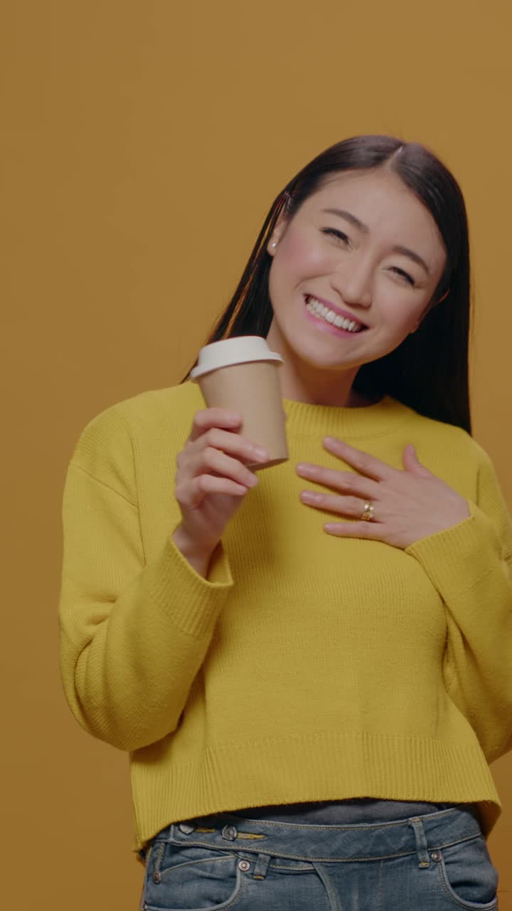 Woman drinking coffee in studio shot