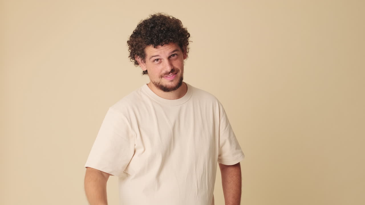 Young Man Reacting with Surprise and Then Smiling