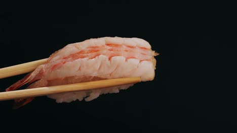 shrimp sushi with chopsticks