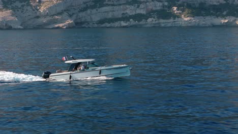 a sleek motorboat glides across the calm sea near nice, france, capturing serene coastal beauty and marine travel. ideal for concepts of adventure, relaxation, and mediterranean escapes.