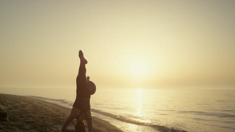 Beautiful-girl-training-twine-standing-on-head-summer-evening.-Woman-exercising.