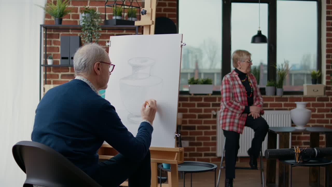 Elder student drawing vase model on canvas in art class