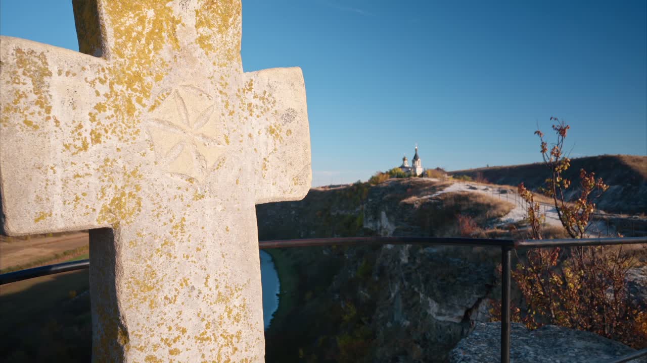 View of an old cross located on a view point in Old Orhei at sunset, Moldova. Raut river on the background
