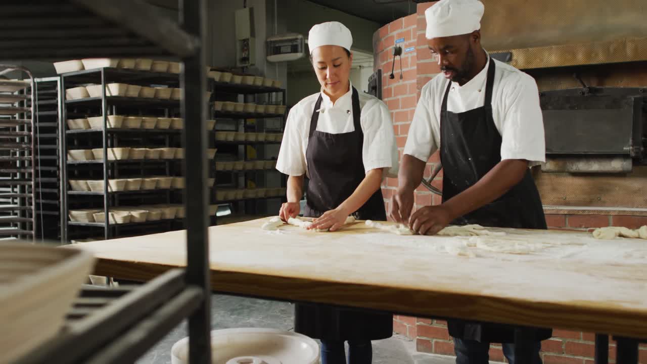 Animation of diverse female and male bakers preparing roll at bakery