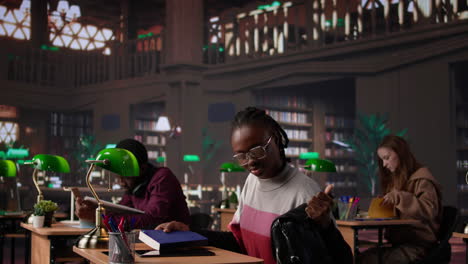 vertical video african american student comparing class notes with data from the library