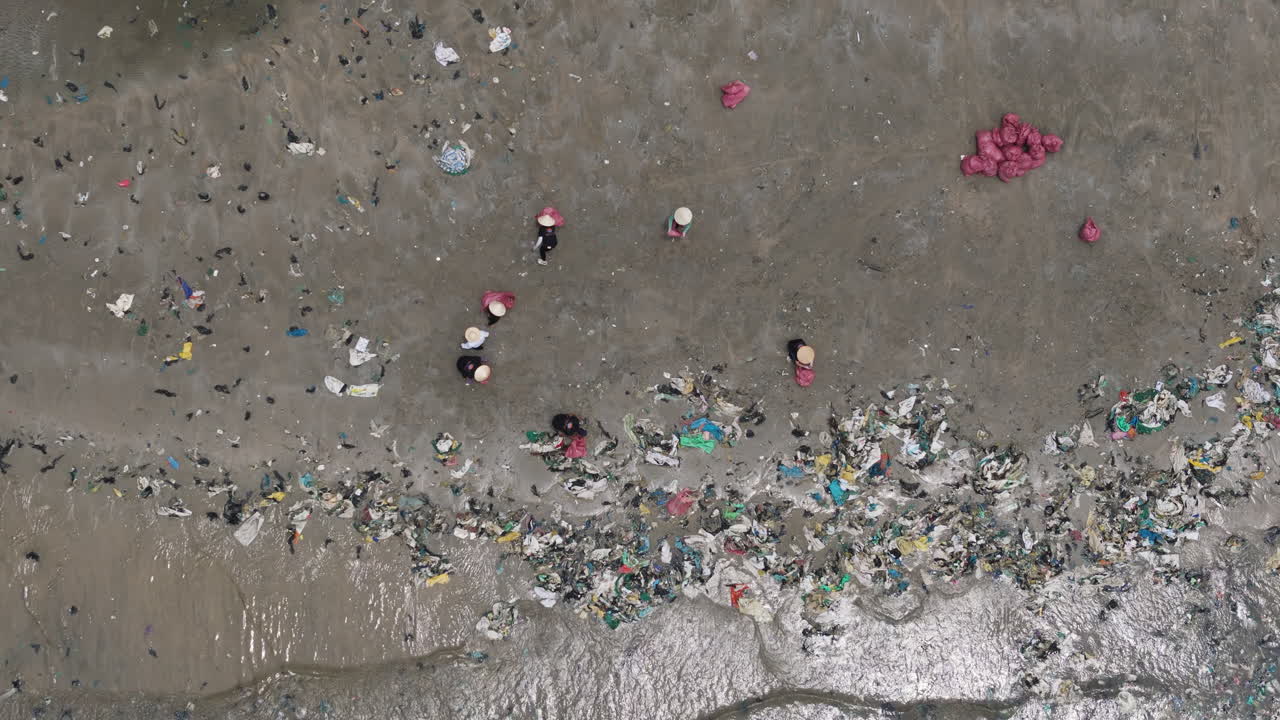 Aerial Top Down of Southeast Asian Villagers in Bamboo Hats Cleaning Plastic Trash from Beach