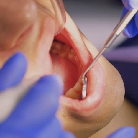 a dentist turns the lamp towards the patient 2