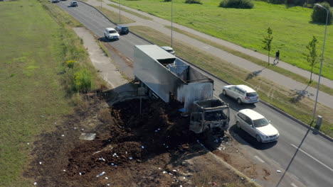 push-in, pan-down view of a white truck after heavy fire damage