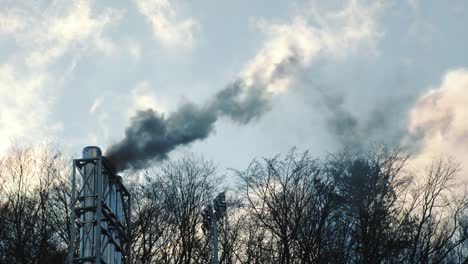 atmospheric polluting industry. black smoke coming out of the chimney. air emissions that change ecology and climate change