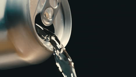 Clear-beverage-liquid-pouring-out-of-silver-can-in-super-slow-motion,-black-background-of-clear-drink-beer-or-wine-at-4k-800fps