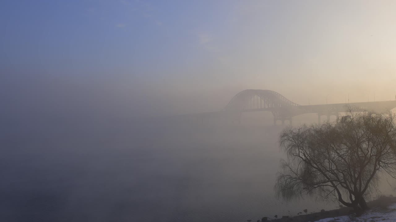 Misty Bridge over River at Sunrise