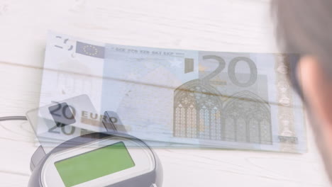 animation of euro banknotes falling over payment terminal