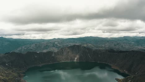 quilotoa volcanic crater lake lagoon near quito, ecuador - aerial descending