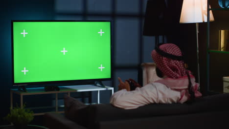 man plays videogames on green screen tv