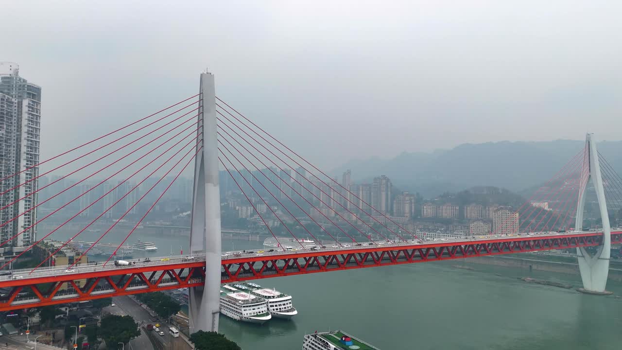 Crane up drone shot of the Twin River Bridges with train and cars above Yangtze River during the day in Chongqing, Yuzhong District, China