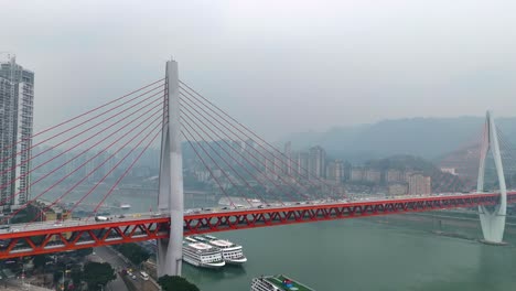 crane up drone shot of the twin river bridges with train and cars above yangtze river during the day in chongqing, yuzhong district, china
