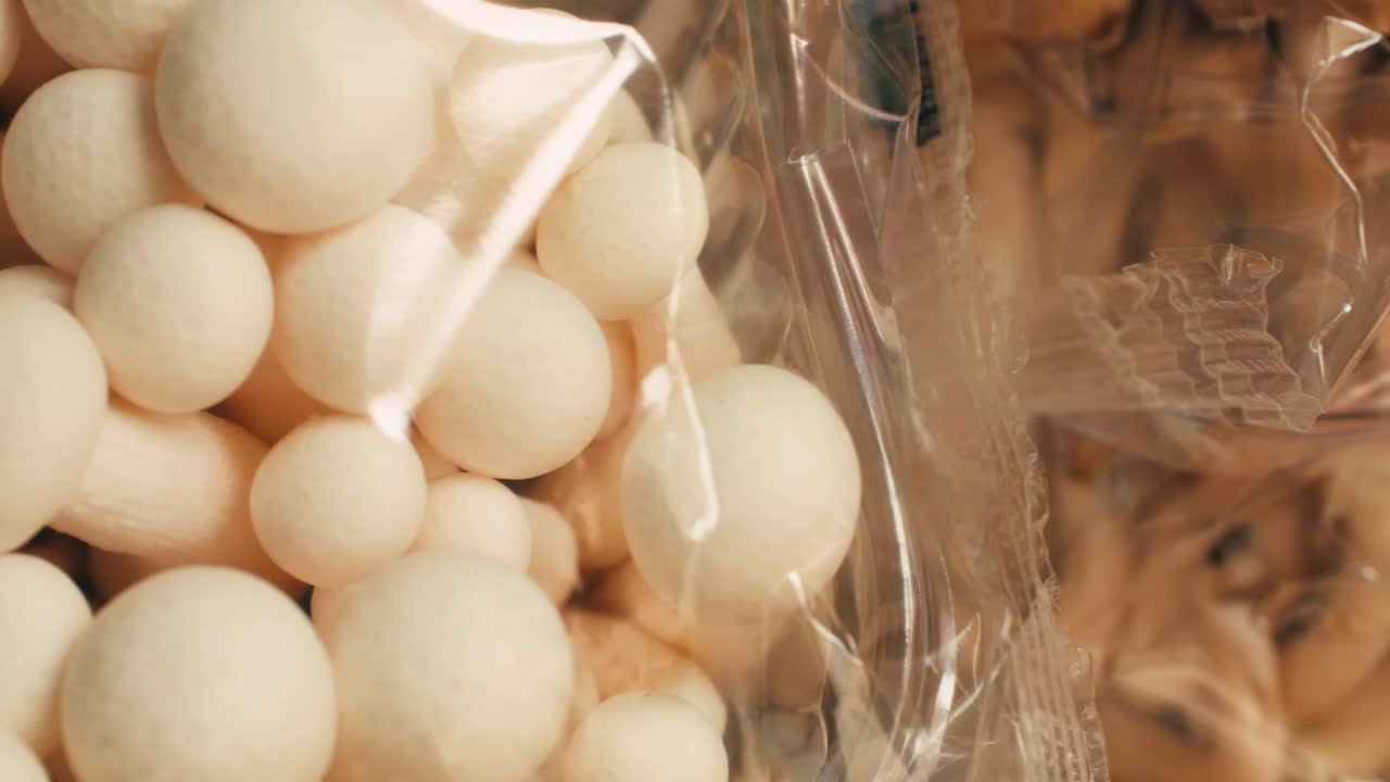 Close-up of packaged white mushrooms
