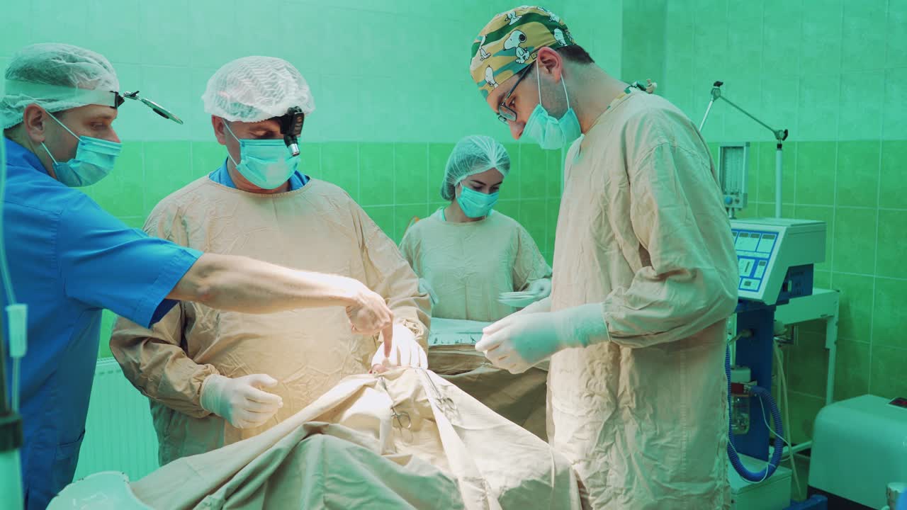 Team of surgeon in uniform perform operation on a patient at surgery clinic