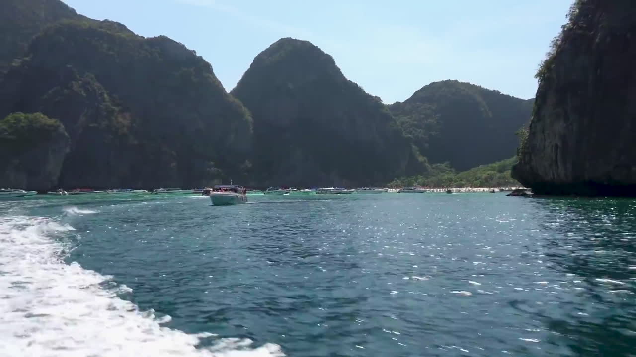 Maya bay in a distance. The view from the boat on island while the boat is moving. Phi Phi Leh. Krabi Province. Thailand.