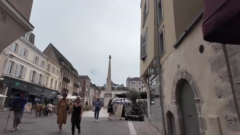 a sunny day in a charming french town square