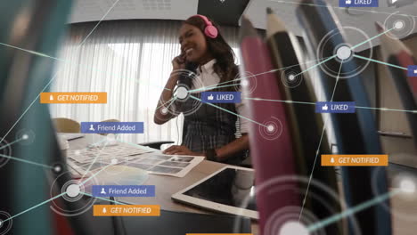 animation of network of connections with text and icons over african american woman with headphones