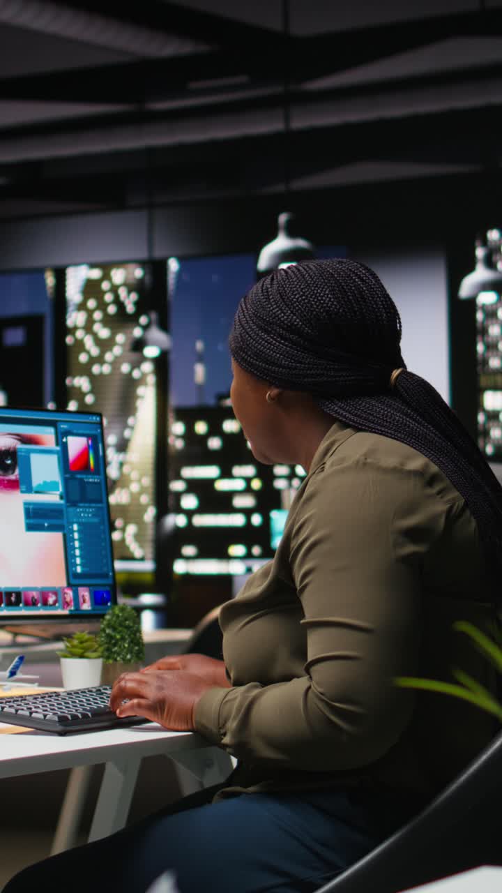 Vertical Video Professional woman uses editing software and AI chatbot on dual monitors