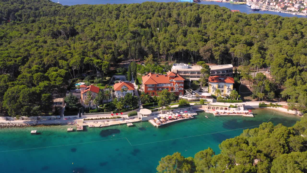 Aerial shot circling a resort in Mali Losinj, Croatia on a bright sunny day