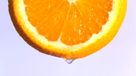 water or oils dropping on an orange slice , fruit for diet and healthy food