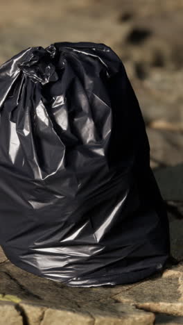 black garbage bag on the ground