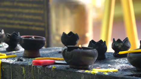 burning candle inside a temple in chiang mai, thailand