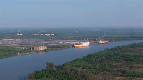 cargo terminal of puerto zarate with cargo ships on parana river. buenos aires, argentina. aerial view.