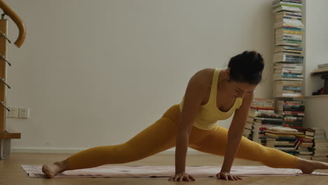 healthy life workout routine, asian pretty girl stretching legs on yoga mat in her apartment room