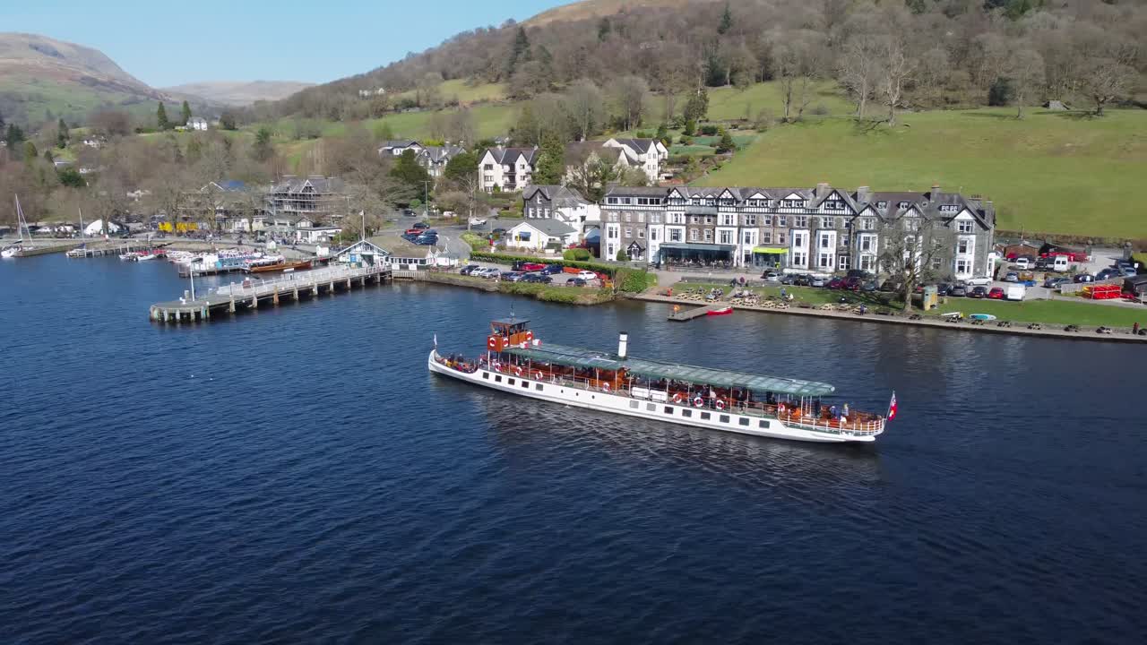 Boat on Windermere Lake near piers of Ambleside