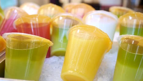 variety of fresh juices in plastic cups