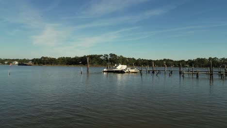 Aerial-pan-view-of-sunken-boat-at-a-dock-in-Alabama