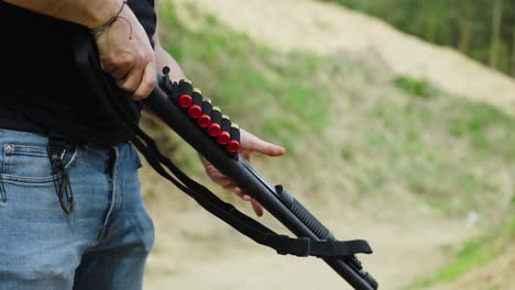 guy hold black shotgun weapon at outdoor olesko shooting range, czechia