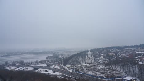 Kyiv-Ukraine-snowy-winter-panorama-with-church-in-background,-handheld