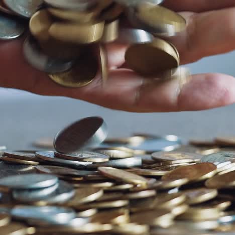 Lot of coins in the hands of men, symbolizing wealth. Slow motion
