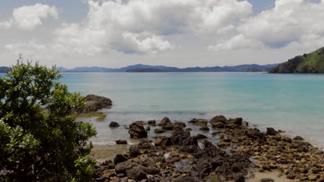 a beautiful and serene rocky beach in russell, new zealand