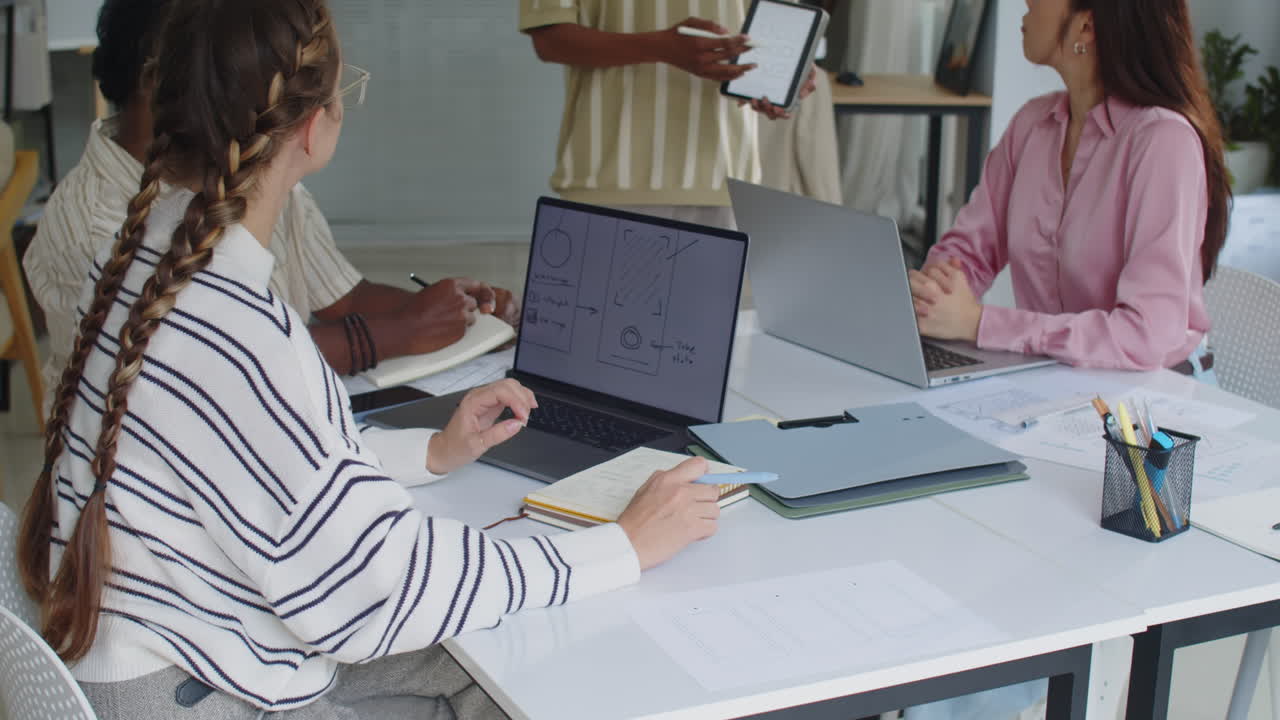 Developers Listening to Product Manager Showing Application Interface