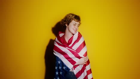 happy woman wrapped in american flag