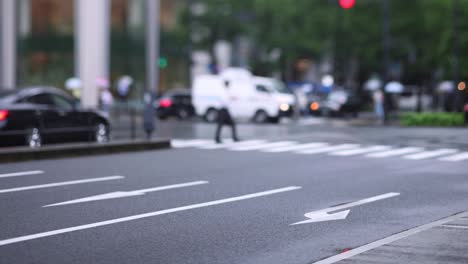 walking people on the street in marunouchi tokyo rainy day