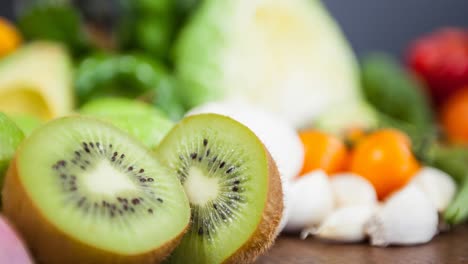 Video-of-fresh-organic-vegan-food-with-kiwi-fruit-and-vegetables-on-wooden-boards