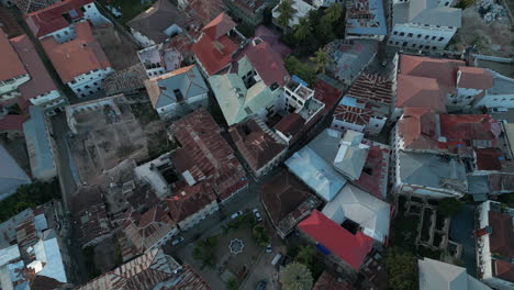 Top-shot-Aerial-view-of-the-Stone-Town,-old-part-of-Zanzibar-City,-main-city-of-Zanzibar-4K-Drone-Tilt-Up-Rooftops